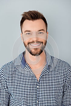 Portrait of handsome bearded young man with beaming smile