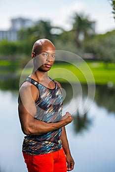 Portrait of a handsome black male fitness model flexing his arm