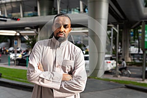 Portrait of handsome black man in city wearing traditional clothes