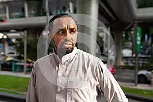 Portrait of handsome black man in city wearing traditional clothes