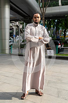 Portrait of handsome black man in city wearing traditional clothes