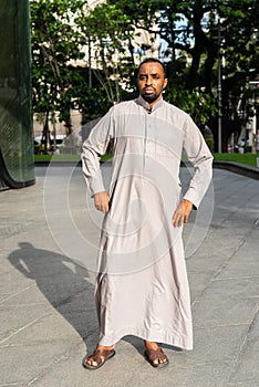 Portrait of handsome black man in city wearing traditional clothes