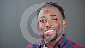 portrait of handsome black man looking at camera and smiling, broadly smile with healthy white teeth