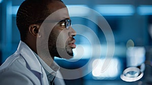 Portrait of Handsome Black Man Wearing Glasses Working Confidently on a Computer. Young Intelligent