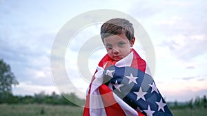 Portrait of handsome boy - american patriot child stands with national flag. USA, 4th of July - Independence day