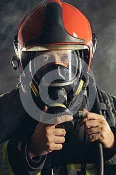 Portrait of handsome brave firefighter in studio