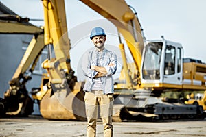 Builder at the shop with heavy machinery