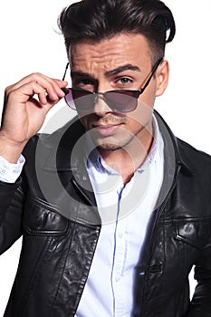 Portrait of handsome busienessman fixing red sunglasses