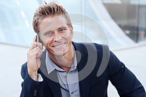 Portrait of handsome business man using cell phone