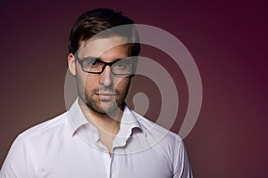 Portrait of handsome businesslike banker in eyeglasses