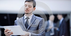 Portrait of handsome businessman on blurred office background