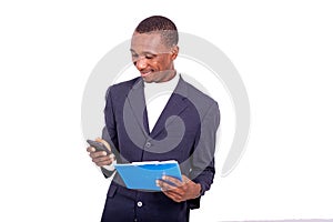 Portrait of a handsome businessman with cellphone and notepad in hand, smiling