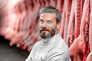 Portrait of a handsome butcher at the manufacturing