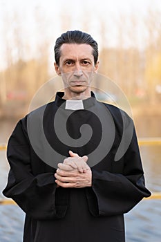 Portrait of handsome catholic priest or pastor with collar