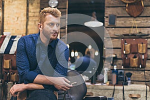Portrait of handsome caucasian male barber with fashionable hairstyle