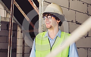 Portrait handsome caucasian male engineer inspecting outdoor at construction site, wearing hard hat for safety, talking, smiling