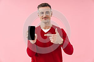 Portrait of handsome caucasian man pointing finger at smartphone