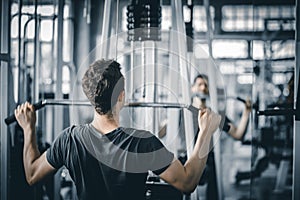 Portrait handsome caucasian young man healthy fitness doing exercise at indoor workout in gym.