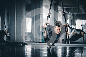 Portrait handsome caucasian young man healthy fitness doing push up at indoor workout in gym.