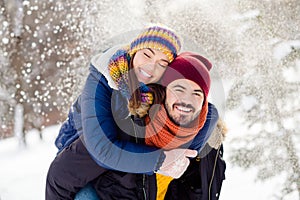 Portrait of handsome cheerful guy hold on back charming lady closed eyes toothy smile have fun outdoors