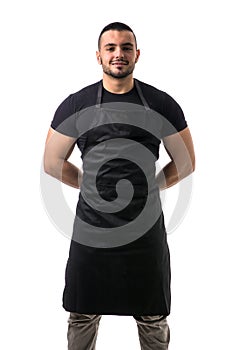 Portrait of handsome chef in black apron