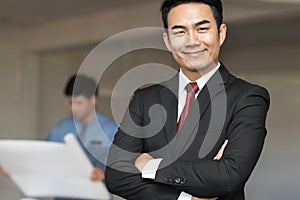 Portrait of handsome confident young businessman smiling