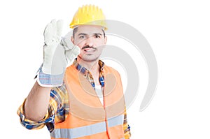 Portrait of handsome engineer or constructor making ok gesture