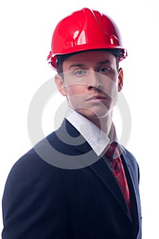 Portrait of handsome engineer with red hardhat on his head