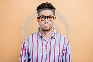 Portrait of handsome entrepreneur young successful businessman wear striped stylish shirt with glasses isolated on beige