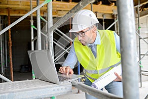 Portrait of handsome foreman construction worker on industrial building industry construction site