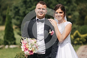 Portrait of handsome groom and charming bride. Romantic atmophere on the wedding