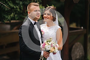 Portrait of handsome groom and charming bride. Romantic atmophere on the wedding