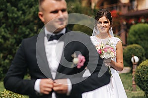 Portrait of handsome groom and charming bride. Romantic atmophere on the wedding