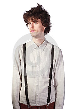 Portrait of a handsome guy in a white shirt with suspenders over