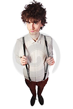 Portrait of a handsome guy in a white shirt with suspenders over