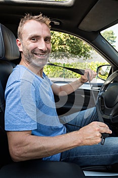 portrait handsome happy business man driving car