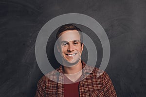 Portrait of handsome happy young man with beaming smile