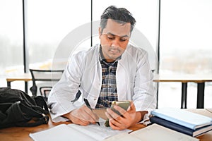 Portrait of a handsome Indian medical student. The concept of higher education.