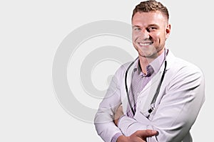 Portrait of handsome male doctor, smiling and looking at camera