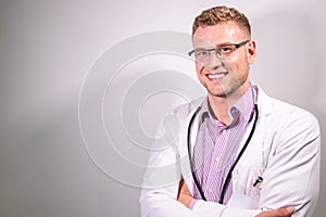 Portrait of handsome male doctor, smiling and looking at camera