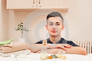 Portrait of handsome male masseur in black apron