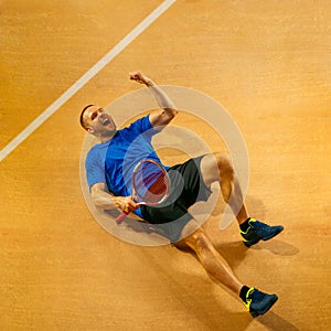 Portrait of a handsome male tennis player celebrating his success at court