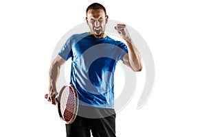 Portrait of a handsome male tennis player celebrating his success isolated on a white background