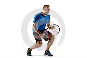 Portrait of a handsome male tennis player celebrating his success isolated on a white background