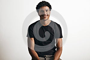 Portrait of a handsome man in black t-shirt sitting