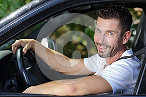 Portrait handsome man in car