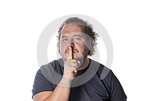 Portrait of handsome man cowering his mouth with his finger