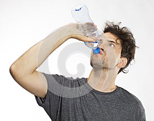 Portrait of a handsome man drinking water. on white