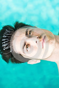 Portrait of a handsome man floating on water