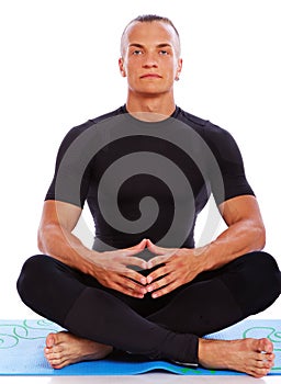 Portrait of handsome man meditating in studio on white backgroun